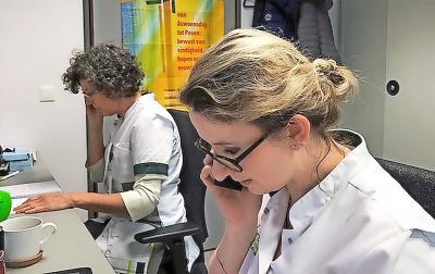 Ann Stevens (links) en Madeleine Burghoorn staan patiënten en hun familie telefonisch bij. © Sint-Trudo Ziekenhuis